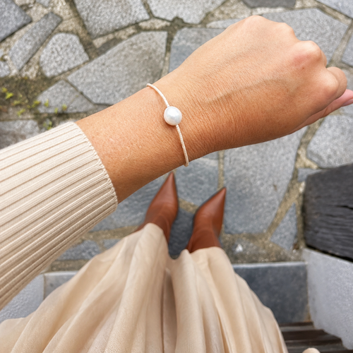 Bracelet hippy avec perle centrale porté avec une tenue pour l'automne