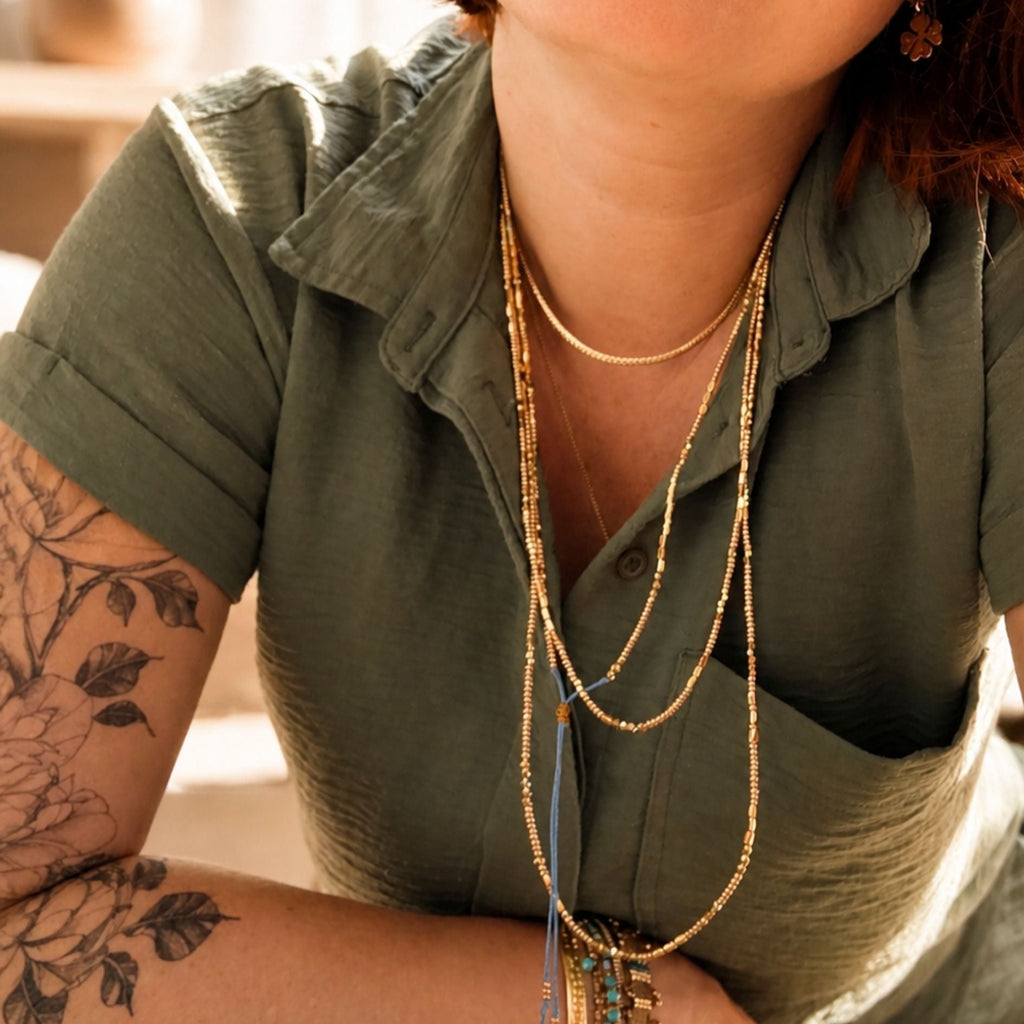 Collier doré à porter en accumulation pour l'été
