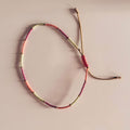Bracelet de cheville Ibiza MarlaH coloris corail, fushia et matcha en perles Miyuki avec cordon ocre à nœud coulissant