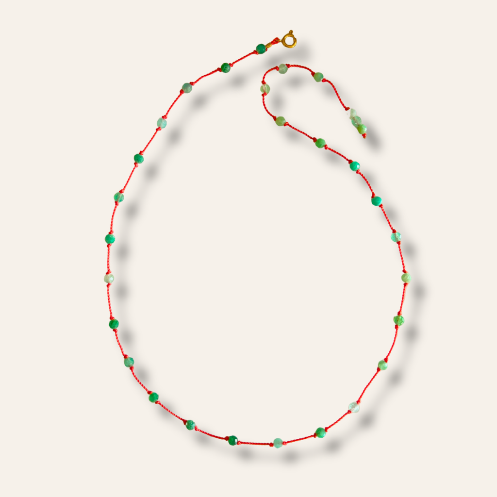 Collier Le Lien en émeraude naturelle posé à plat, fermoir mousqueton doré